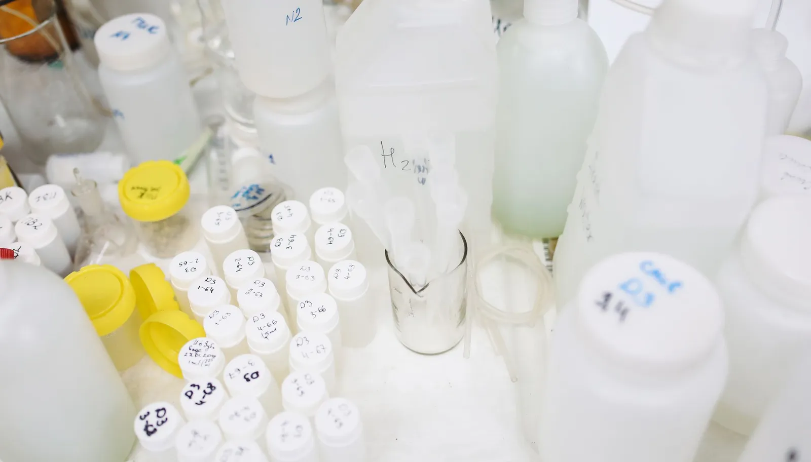 Plastic bottles and containers lined up in a quality-control laboratory